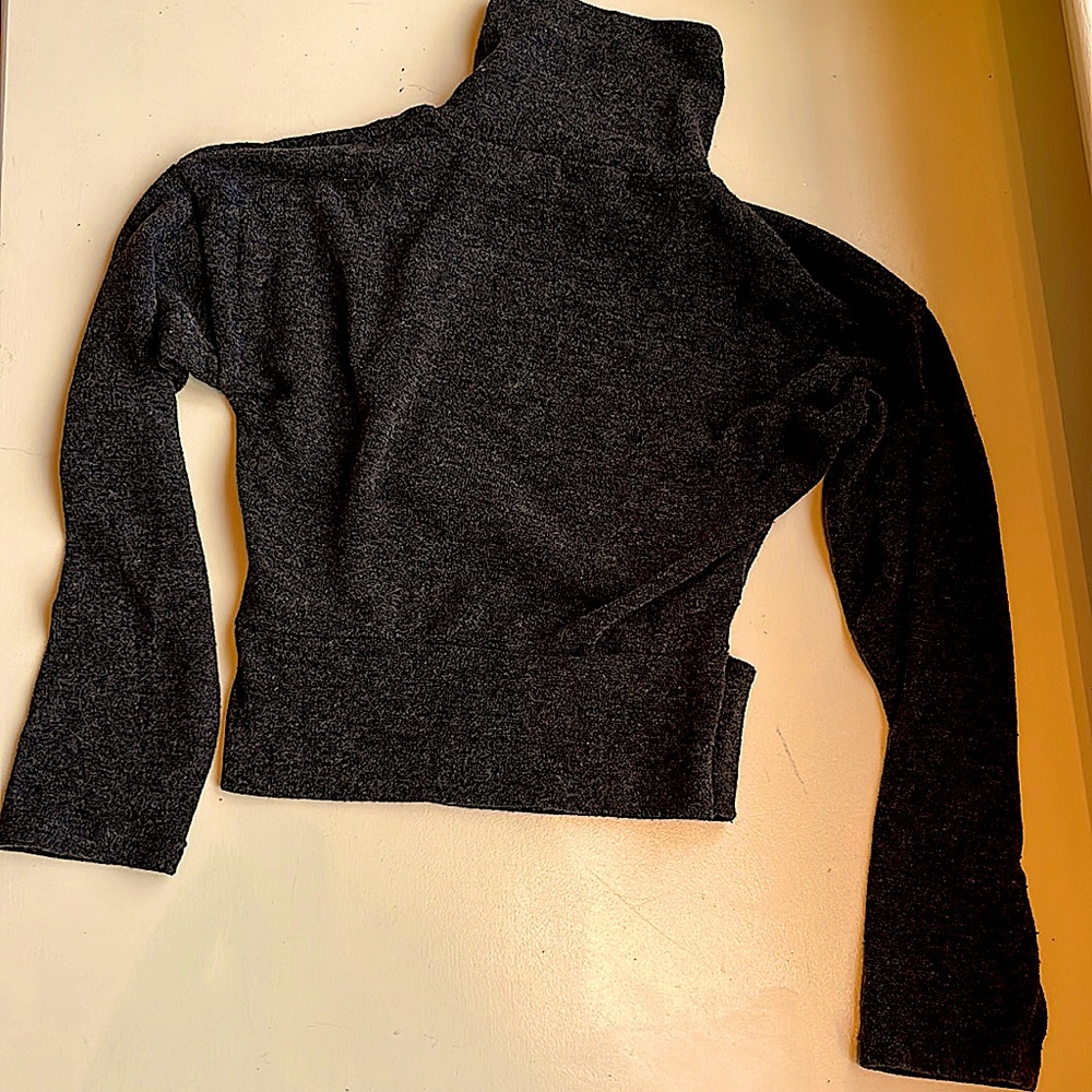 A blackish/grayish sweater with a back slit. Lightly used. No damage.